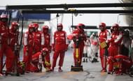 SAKHIR, BAHRAIN - APRIL 21: Ferrari mechanics wait for a pitstop during the Bahrain Formula One Grand Prix at the Bahrain International Circuit